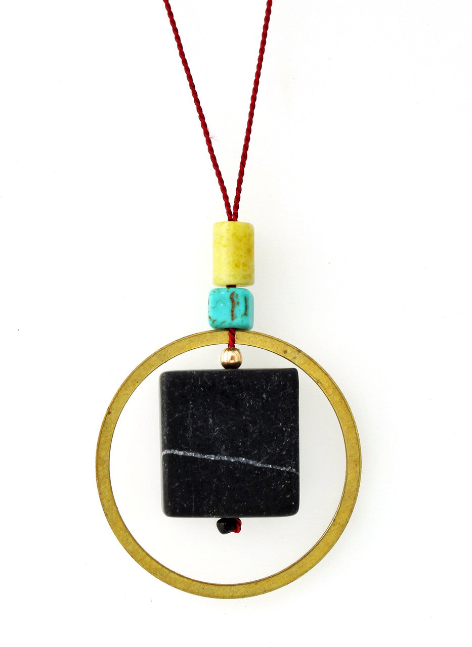 BLACKSTONE, PERIDOT JASPER, MAGNESITE AND BRASS CIRCLE NECKLACE ON RED SILK